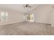 Spacious bedroom with neutral carpet, a ceiling fan, and a sliding glass door leading to the patio at 1424 W Mead Dr, Chandler, AZ 85248