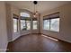 Sunlit dining area featuring tile flooring, multiple windows, and a modern pendant light fixture at 1424 W Mead Dr, Chandler, AZ 85248