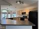 Well-lit kitchen with black appliances, light wood cabinetry, and a view of the neighborhood at 1424 W Mead Dr, Chandler, AZ 85248