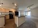Open kitchen design with a central island, neutral cabinets, and black appliances at 1424 W Mead Dr, Chandler, AZ 85248