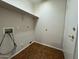 Laundry room features connections for washer and dryer, plus overhead shelving at 1424 W Mead Dr, Chandler, AZ 85248