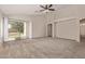Expansive living room with neutral carpet, a ceiling fan, and a sliding glass door for seamless outdoor access at 1424 W Mead Dr, Chandler, AZ 85248