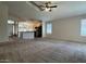 Spacious living room featuring new carpeting, high ceilings, and a view of the kitchen at 1424 W Mead Dr, Chandler, AZ 85248