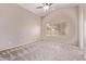 Spacious main bedroom with plush carpeting, ceiling fan, and a bright window at 1424 W Mead Dr, Chandler, AZ 85248