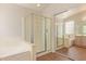 Bright bathroom with a glass-enclosed shower, soaking tub, and tile floors at 1424 W Mead Dr, Chandler, AZ 85248
