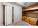 Unfinished basement with shelving and wood-paneled built-ins, ready for a transformation at 1431 E 1St St, Mesa, AZ 85203