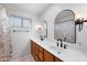 Bathroom with a double vanity, wood cabinets, and matching mirrors, creating a harmonious and functional space at 1431 E 1St St, Mesa, AZ 85203