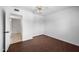 Bedroom featuring wood floors and a ceiling fan, with convenient access to an adjacent bathroom at 1431 E 1St St, Mesa, AZ 85203