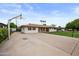 Exterior view of the single-story home with a spacious driveway and well-maintained landscaping at 1431 E 1St St, Mesa, AZ 85203