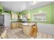 Cozy kitchen with tiled floors, granite countertops, wood cabinets, and breakfast bar with stools at 1431 E 1St St, Mesa, AZ 85203