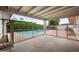 Covered patio overlooking a fenced pool area with desert landscaping and a block privacy wall at 1431 E 1St St, Mesa, AZ 85203