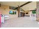 Back patio features ceiling fans, a built-in grill, and stone columns at 1435 E Rancho Dr, Phoenix, AZ 85014