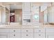 Modern bathroom featuring and sinks, white cabinetry, and a large mirror at 1435 E Rancho Dr, Phoenix, AZ 85014