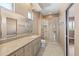Bright bathroom with a granite counter, ample storage and a tiled glass shower at 1435 E Rancho Dr, Phoenix, AZ 85014