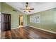 Bedroom with wood floors, ceiling fan, and window with plantation shutters at 1435 E Rancho Dr, Phoenix, AZ 85014