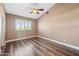 A well-lit bedroom with a ceiling fan and hardwood floors at 1435 E Rancho Dr, Phoenix, AZ 85014