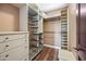 A walk-in closet with custom shelving, wire basket storage and hardwood floors at 1435 E Rancho Dr, Phoenix, AZ 85014