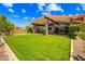 Stunning home exterior with lush artificial turf, landscaping, and covered patio at 1435 E Rancho Dr, Phoenix, AZ 85014