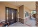 Elegant front door with decorative glass panels, stone accents, and a covered porch at 1435 E Rancho Dr, Phoenix, AZ 85014