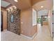 Hallway showcasing neutral tones, a decorative mirror, and stone accents that add architectural detail at 1435 E Rancho Dr, Phoenix, AZ 85014
