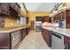 Modern kitchen with stainless steel appliances, wine fridge, and tile floors at 1435 E Rancho Dr, Phoenix, AZ 85014