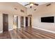 Large living room with high ceilings, wood floors, multiple windows, and access to several rooms at 1435 E Rancho Dr, Phoenix, AZ 85014