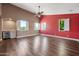 Spacious living room features hardwood floors, many windows, a wet bar, and a ceiling fan at 1435 E Rancho Dr, Phoenix, AZ 85014