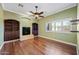 Spacious living room with hardwood floors, fireplace, built-in shelving, and large windows at 1435 E Rancho Dr, Phoenix, AZ 85014