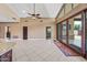 Open-concept living room with tile flooring and sliding glass doors to the patio at 1435 E Rancho Dr, Phoenix, AZ 85014