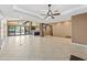 Large living space with tile floors, expansive windows, and a seamless flow into the kitchen area at 1435 E Rancho Dr, Phoenix, AZ 85014