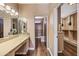 A spacious walk-in closet with a vanity and ample storage on hardwood floors, with two entrances at 1435 E Rancho Dr, Phoenix, AZ 85014