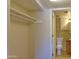 Open closet with shelves providing storage space, leading to the bathroom at 151 E Broadway Rd # 206, Tempe, AZ 85282
