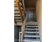 View of the home's entryway with brown front door and concrete stairs leading up to the unit at 151 E Broadway Rd # 206, Tempe, AZ 85282