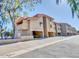 View of the condos with personal carport spaces under the units and red tile roofing at 151 E Broadway Rd # 206, Tempe, AZ 85282