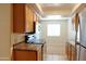 Kitchen with stainless steel appliances, oak cabinets, granite countertops and tile flooring at 151 E Broadway Rd # 206, Tempe, AZ 85282