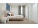 Cozy bedroom showcasing a comfortable bed, stylish wallpaper, and a well-lit window at 15597 W Williams St, Goodyear, AZ 85338