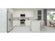 Bright kitchen with stainless steel appliances, granite countertops, and modern white cabinetry at 15597 W Williams St, Goodyear, AZ 85338