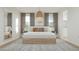 Spacious main bedroom with a view of the windows and elegant decor at 15597 W Williams St, Goodyear, AZ 85338