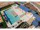 Aerial view of the community pool area, highlighting sunshades, seating, and the inviting pool and hot tub at 15797 W Kendall St, Goodyear, AZ 85338