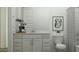 Bathroom featuring a vanity with marble countertop, framed mirror, and art creating an elegant and functional space at 15797 W Kendall St, Goodyear, AZ 85338