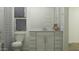 Bright bathroom with white vanity, neutral walls, and artwork above the toilet, creating a soothing atmosphere at 15797 W Kendall St, Goodyear, AZ 85338