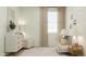 Calming Bedroom featuring a white crib, dresser, and accent chair, complemented by soft lighting and cloud-patterned wallpaper at 15797 W Kendall St, Goodyear, AZ 85338