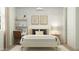 Calm bedroom featuring a bed with decorative pillows, side table with lamp, and a cozy rug at 15797 W Kendall St, Goodyear, AZ 85338