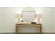 Entryway featuring a wooden console table with lamps, a round mirror, and decorative items for a welcoming space at 15797 W Kendall St, Goodyear, AZ 85338