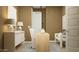 Stylish home office with a modern desk, sleek chandelier, and comfortable seating arrangement for a productive atmosphere at 15797 W Kendall St, Goodyear, AZ 85338