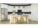 Contemporary kitchen boasting white cabinets, stainless steel appliances, and a center island with bar stool seating at 15797 W Kendall St, Goodyear, AZ 85338