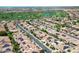 Aerial view of a neighborhood with solar panels and a golf course in the distance at 1804 E Sattoo Way, Queen Creek, AZ 85140