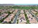 Panoramic aerial shot of a charming neighborhood boasting lush landscaping, solar panels, and a picturesque golf course at 1804 E Sattoo Way, Queen Creek, AZ 85140
