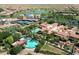 Beautiful aerial view of the community clubhouse, pools, tennis courts, and surrounding landscape at 1804 E Sattoo Way, Queen Creek, AZ 85140