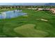 Aerial view of the immaculate golf course including a green, sand bunker, lake and partial community at 1804 E Sattoo Way, Queen Creek, AZ 85140